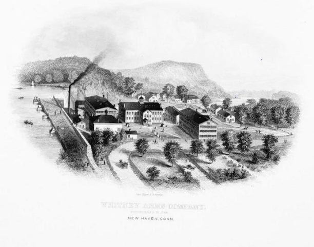 The Whitney Arms Company on the Mill River, with East Rock behind it.