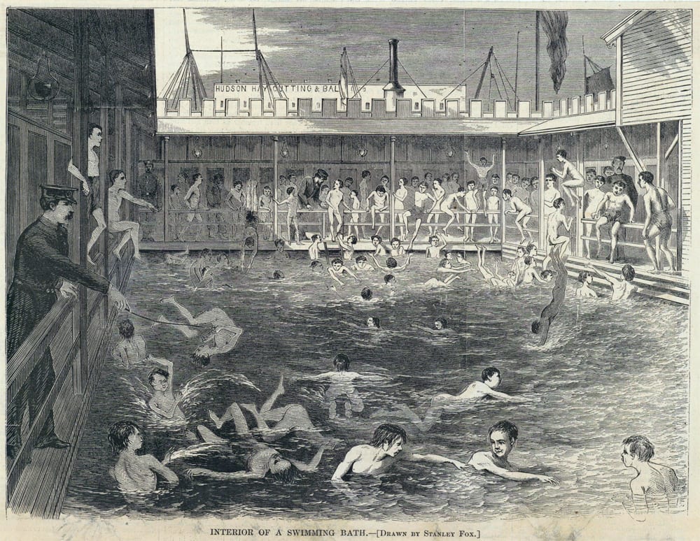 The interior of a public swimming bath, packed to the rails.